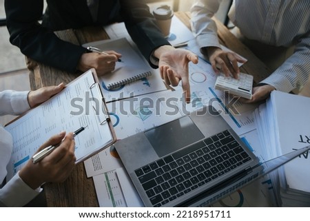 Team of business investment consultant analyzing company annual financial report working with documents pie and donut chart, using laptop, Business and Financial concept. Royalty-Free Stock Photo #2218951711