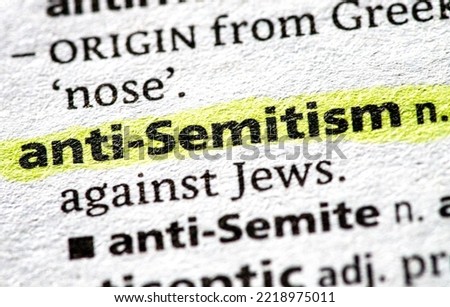 Close up photo of the words anti semitism in a dictionary book Royalty-Free Stock Photo #2218975011
