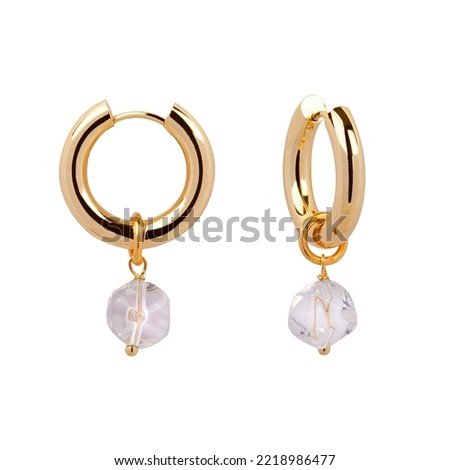 Gold earrings isolated on white background  Royalty-Free Stock Photo #2218986477