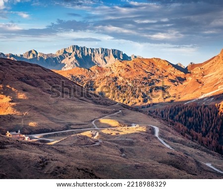 Amazing autumn landscape Dolomite Alps. Captivating evening view of popular tourist destination - Baita Segantini. Attractive outdoor scene of Italy, Europe. Traveling concept background.