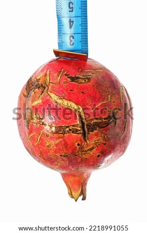 pomegranate with measuring tape isolated on white background