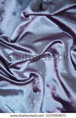 The texture of the fabric is in with a lilac shine. Textile industry for the creation of clothing.