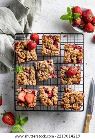 Homemade crumble strawberry bars with oatmeal on the table top view flat lay. Vertical orientation Royalty-Free Stock Photo #2219014219