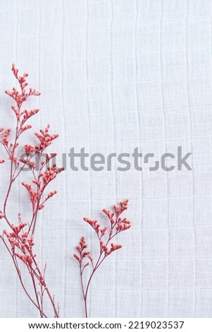 Beautiful flower arrangement. Small branches of flowers, free space for text on a light pastel background. top view, copy space
