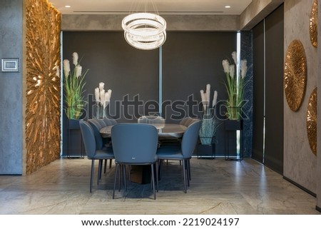Roller blinds in the interior. Automatic blackout shades large size on the windows. Modern interior with wood decor panels on the wall. Plants in hi-tech flower pots. Electric curtains for home. Royalty-Free Stock Photo #2219024197