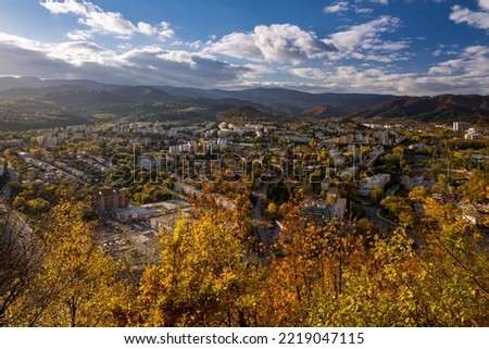Fall in Banska Bystrica. City landscape with forests and mountains around. Autumn colored and at sunset. Royalty-Free Stock Photo #2219047115