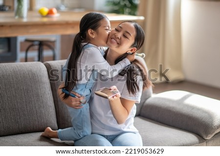 Loving child kissing her mother on the cheek