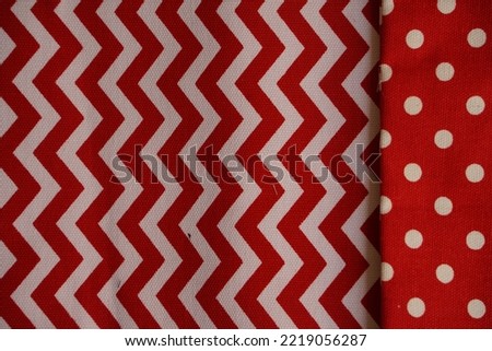Polka dots and zigzag in red and white fabric to make abstract background and texture