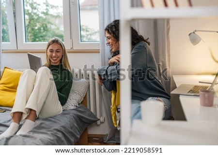 friends talking in dormitory room Royalty-Free Stock Photo #2219058591