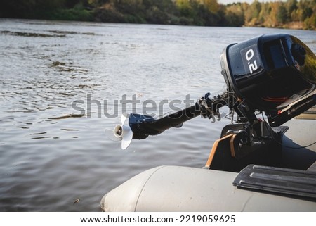 outboard motor on a boat over water Royalty-Free Stock Photo #2219059625