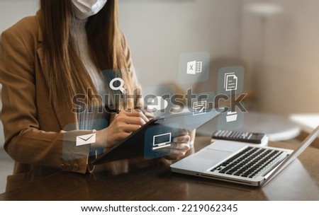Social media and Marketing virtual icons screen of business women typing keyboard with laptop computer and tablet at office.