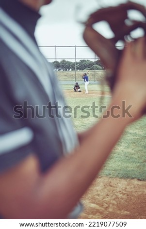 Baseball, sports and fitness with a batter and pitcher on a grass pitch or field during a game or match. Exercising, training and workout with a baseball player playing in a competitive sport