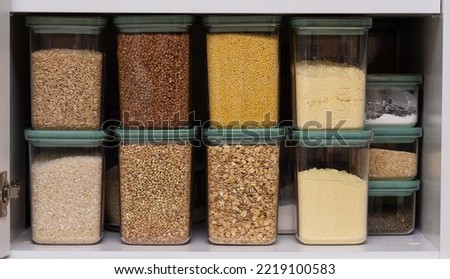 Set of cereals in a jar, rice chickpeas lentil oats millet healthy food and diet concept. Cereals in containers, buckwheat, oatmeal, millet, rice, green buckwheat.