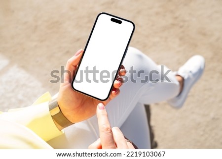 Mobile phone mockup, woman using phone outside Royalty-Free Stock Photo #2219103067