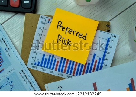 Concept of Preferred Risk write on sticky notes with Statistics isolated on Wooden Table. Selective focus on preferred risk text