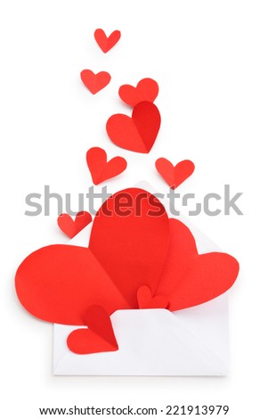 Envelope and red paper hearts isolated on white background.