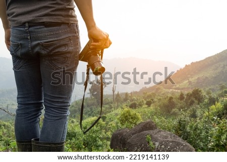 close up shot of Asian man catching camera travel alone at mountain and look at far a way adventure alone, nature travel and environment concept computer sunrise light, copy space for individual text