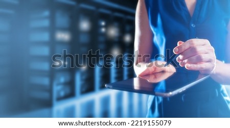 System administration. Woman hands with tablet. Hosting server with neon glow. Hosting company employee. Concept of hosting equipment administration. Data storage and processing business
