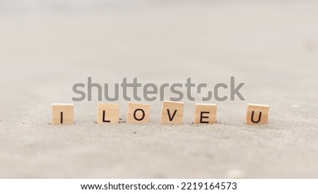 I love you word Written With Blocks On sand