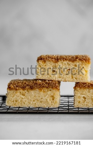Danish Dream Cake Drømmekage. Sponge cake with coconut topping on a light background. 