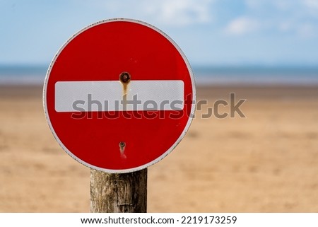 A no parking sign on the beach