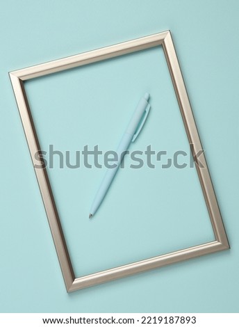 Pen in a golden frame on a blue background