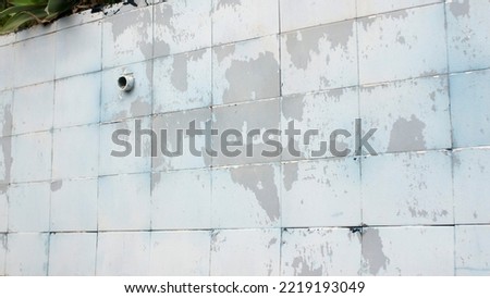 Blue paint tiled weathered  wall