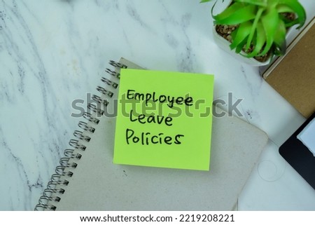 Concept of Employee Leave Policies write on sticky notes isolated on Wooden Table. Royalty-Free Stock Photo #2219208221
