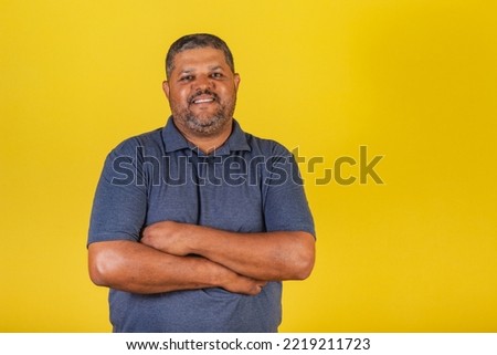Brazilian man, adult smiling looking at camera. With arms crossed confident Royalty-Free Stock Photo #2219211723