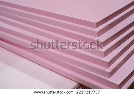 Pink Extruded Polystyrene XPS foam thermal insulation boards stacked in the construction site. High Density, water absorption. Eco energy saving technology Royalty-Free Stock Photo #2219219757