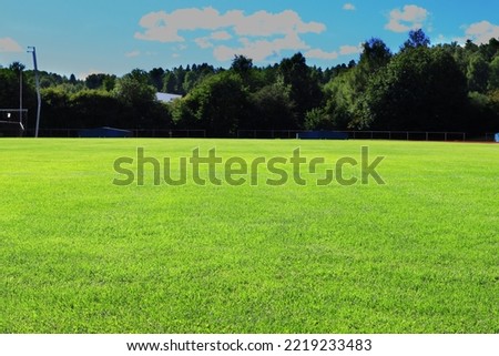 Great green grass lawn. Used for sports and athletics. Summer day outside. Stockholm, Sweden.