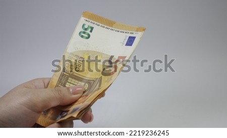 Close-up of two hands of people exchange a 50 euro notes to buy and sell. High quality photo.Big amount of 50 euro banknotes close-up. Rich life conceptual.