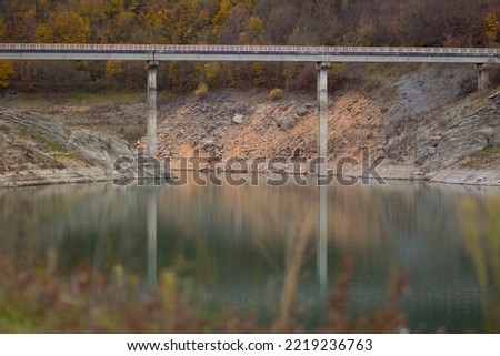 bridge over a mountain lake in the autumn