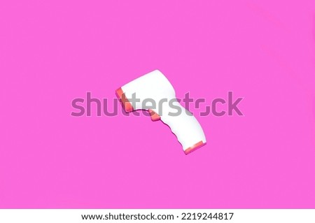 medical contactless thermometer on magenta background