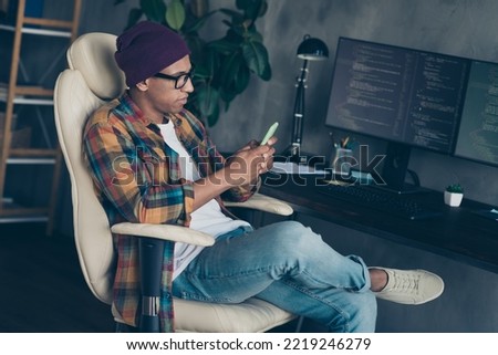 Profile photo of focused concentrated professional hacker sit chair use telephone workstation indoors