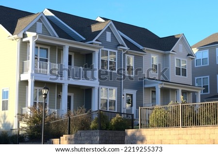 Townhouses in a housing community. Home ownership or rental units for investment portfolio. Royalty-Free Stock Photo #2219255373
