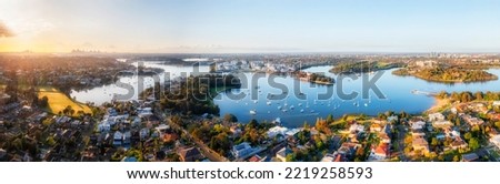 Greater Sydney in wide aerial panoram along Parramatta river from city CBD to Western Sydney suburbs.