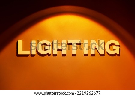 Lighting - Single word in electric light spot and space for your own text Royalty-Free Stock Photo #2219262677