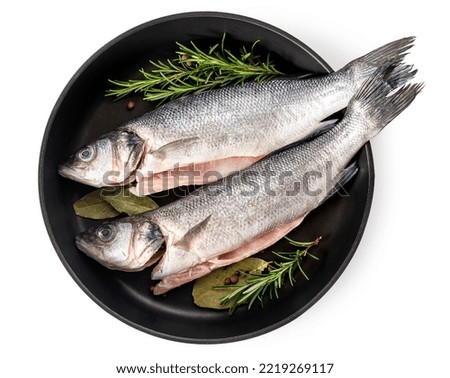 Sea bass fish. Two peeled raw sea bass, spices and rosemary branches in a skillet Royalty-Free Stock Photo #2219269117