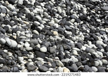 Round cut lava stones on the beach, southwest coast, island of Sao Miguel, Azores, Portugal