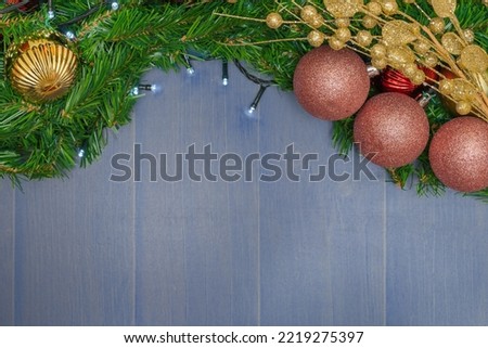 bluish-gray Christmas background, with balls and pine branches. 