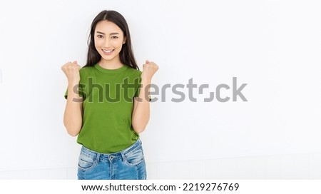 Portrait of beautiful smiling positive happy asian woman her fists up. Closeup delight excited face girl wearing grey t-shirt. People lifestyle successful triump victory panoramic banner