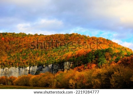 Sunset photo during the autumn as the trees change color at Roark Bluff in Steel Creek Campground along the Buffalo River located in the Ozark Mountains, Arkansas. 