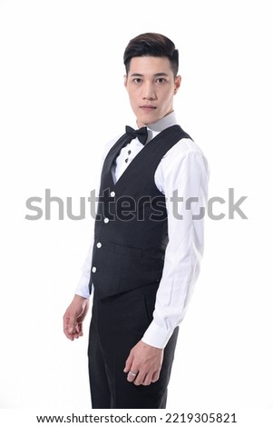 portrait of a young businessman in wear white shirt with bow tie on white background