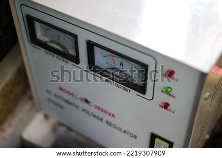 Defocussed abstract background of voltage regulator. Electricity, power, and voltage background concept. Royalty-Free Stock Photo #2219307909