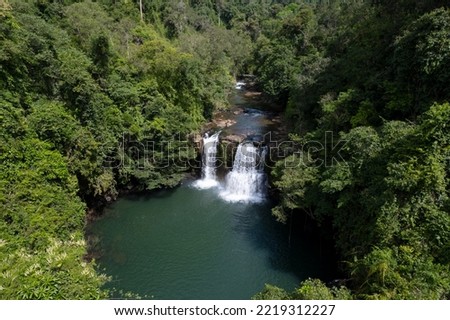 Aerial view Waterfall of Natural Forest through trees and mountain mysterious, Waterfall in Thailand.