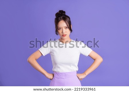 Portrait of a beautiful Asian woman posing on a purple background Royalty-Free Stock Photo #2219333961
