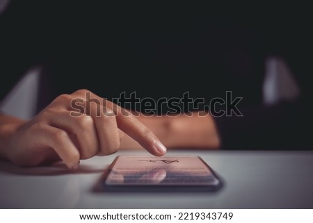 Woman finger signing contract on mobile phone screen. Concept of signing legally binding contracts through paperless remote communication tools.
