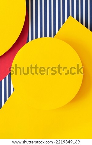 Abstract trendy fashion colored papers texture background in memphis geometry style. Yellow, red, blue, white colors. Geometric shapes and striped lines. Top view, flat lay