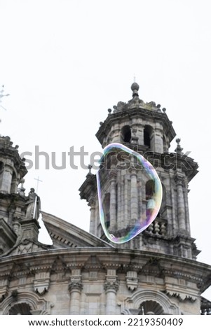 A soap bubble floats in front of the Virgen Peregrina church in the village of Pontevedra (Spain) Royalty-Free Stock Photo #2219350409